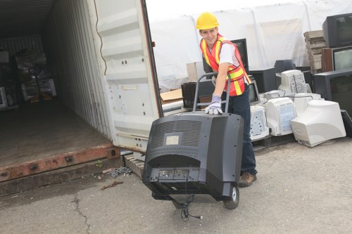 Workers wearing PPE and loading a van safely
